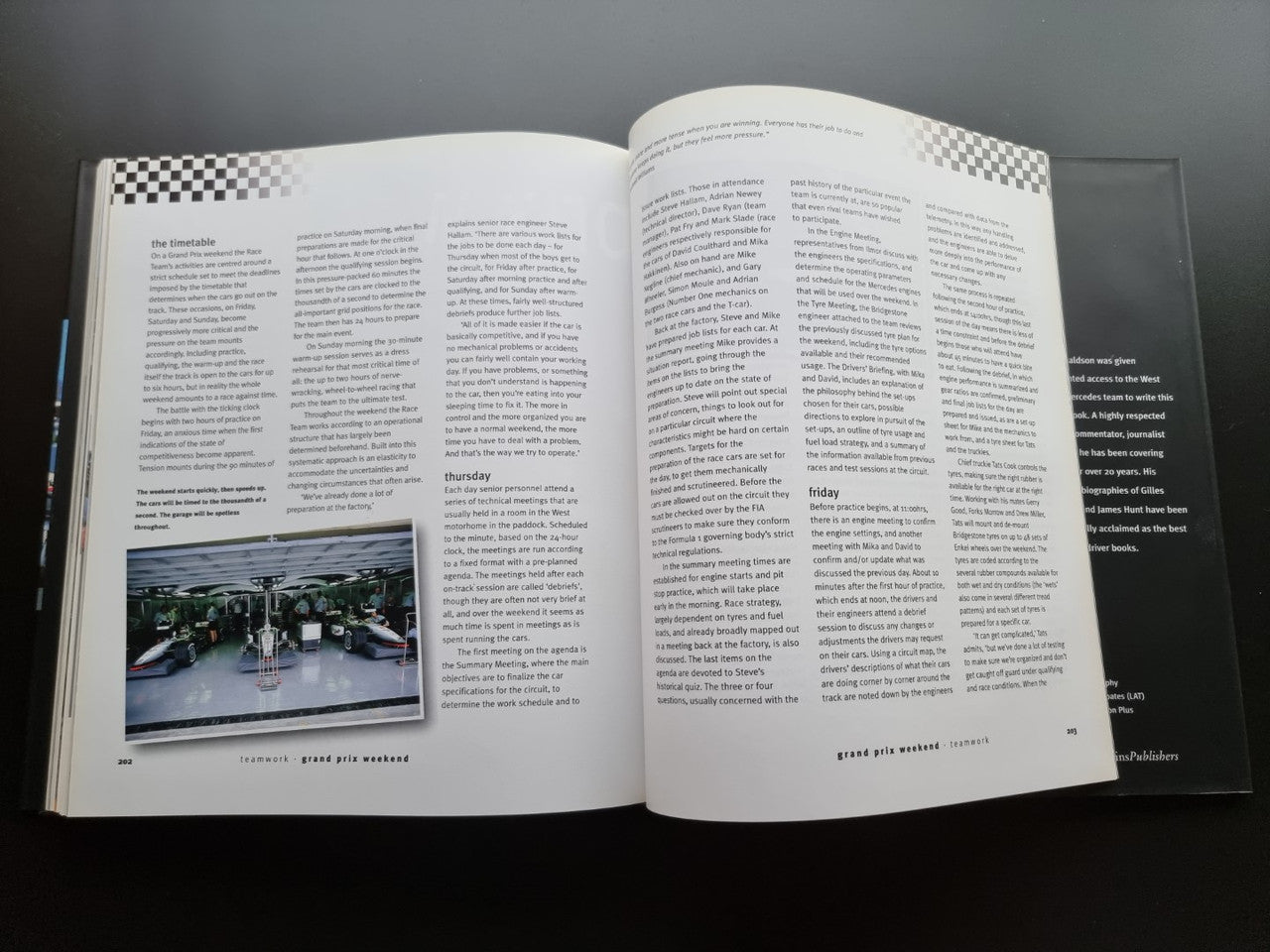 Open biography book with dense text and a small group photo near bottom