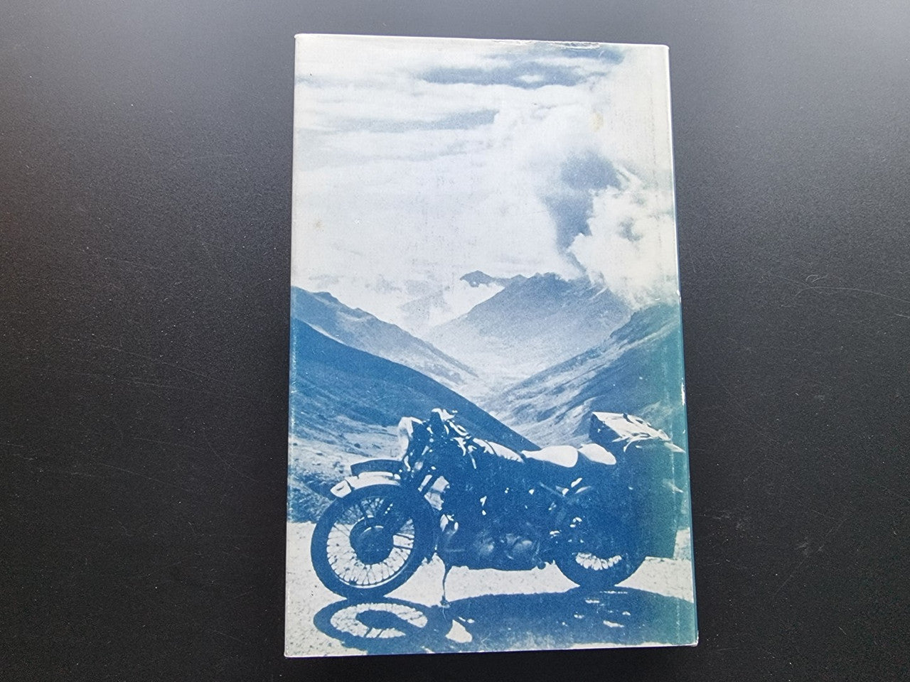 Motorcycle workshop book cover with a blue landscape photo and motorcycle