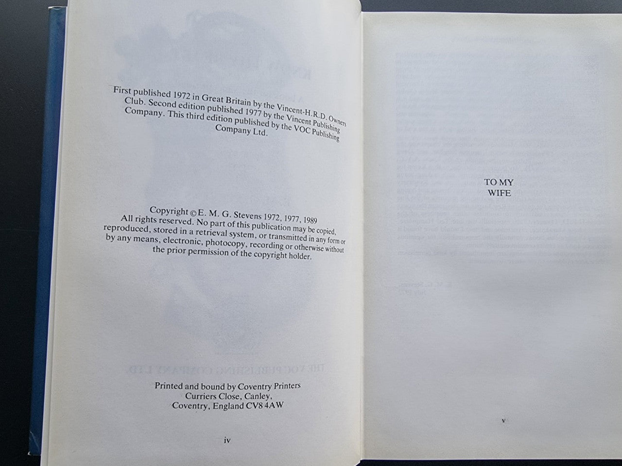Inside book pages: copyright text on left, 'To my wife' line on right