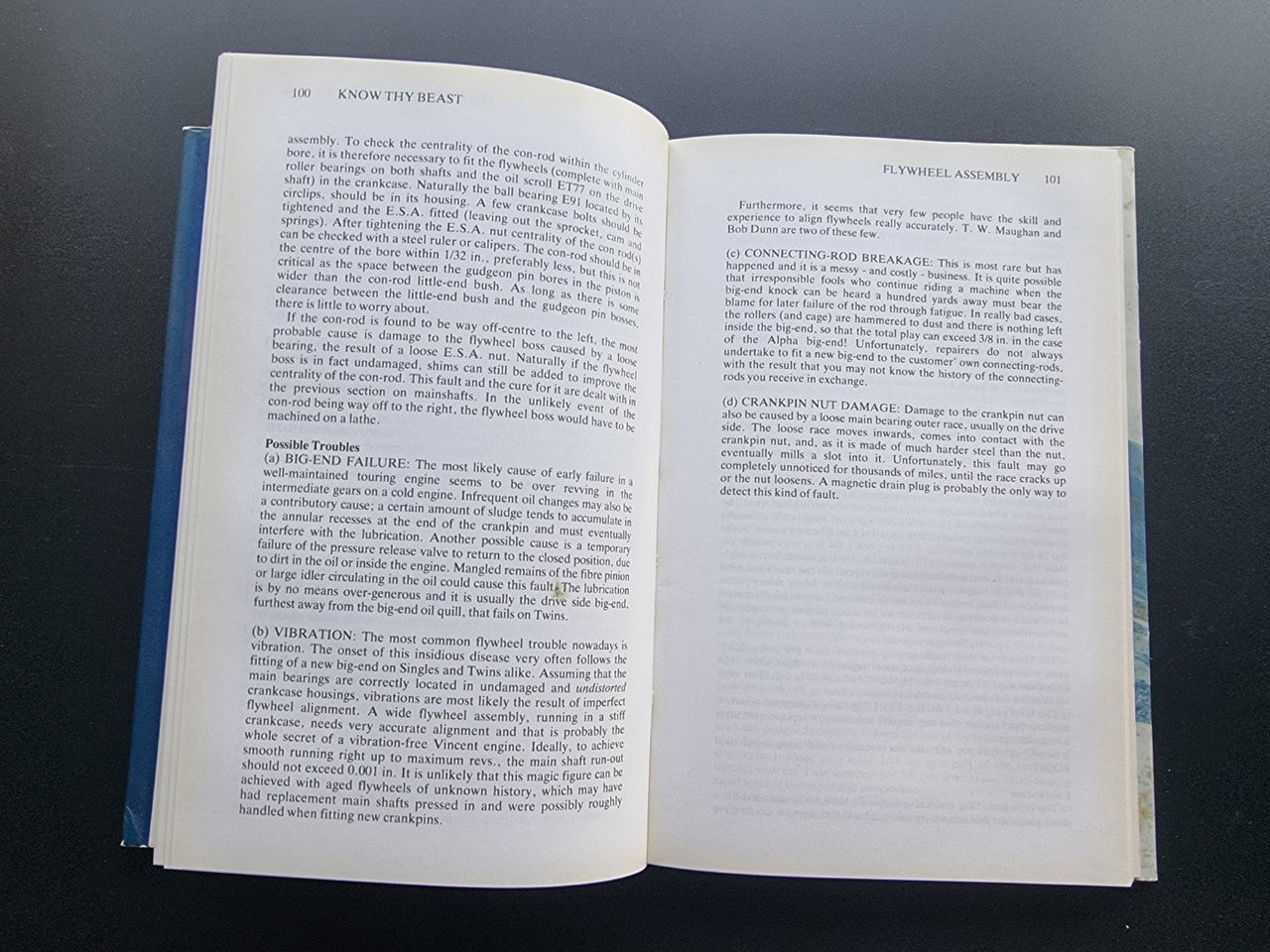 Motorcycle workshop book open to technical text pages and appendix notes