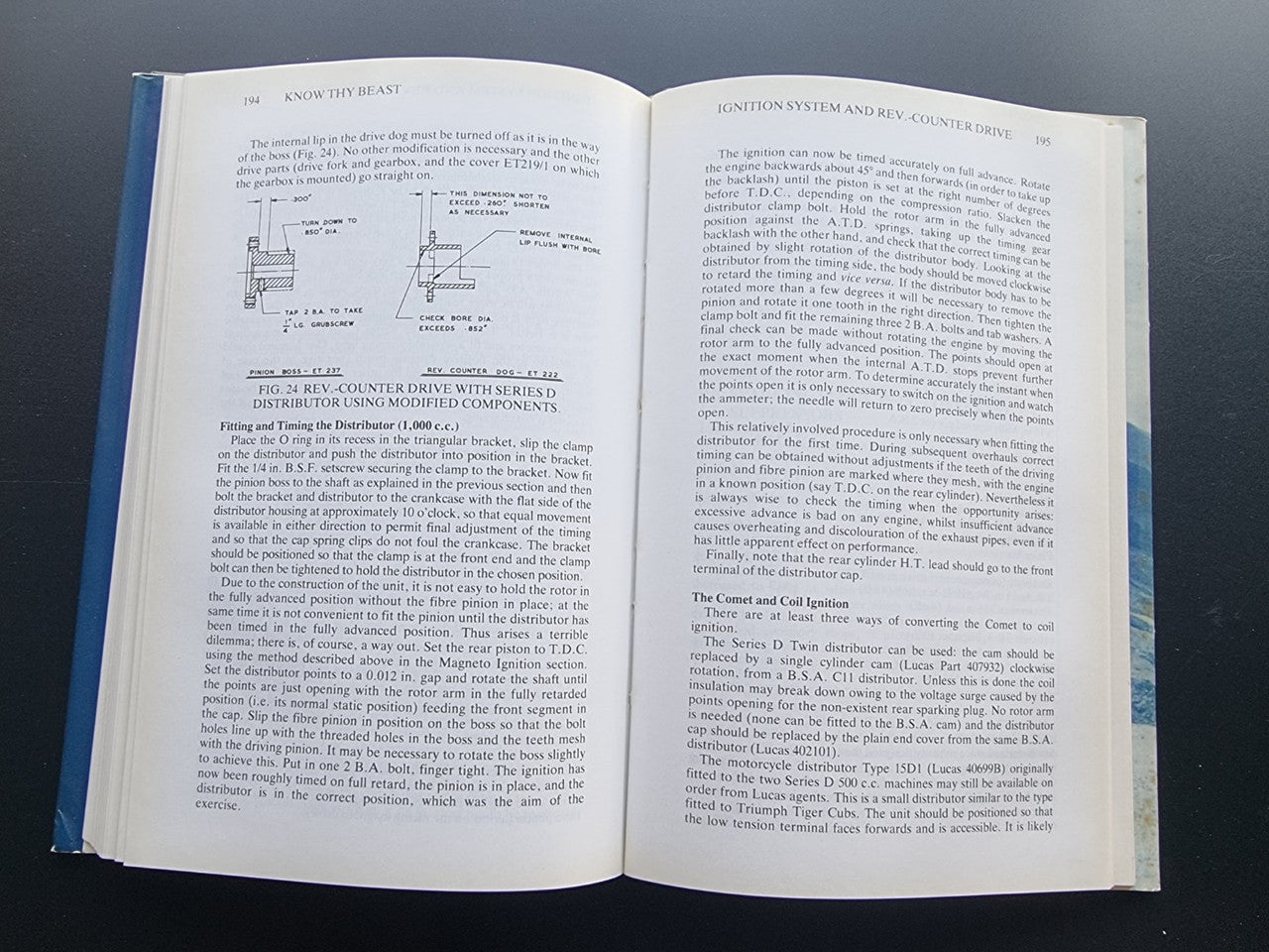 Motorcycle workshop book opened to dense technical pages with labeled schematics