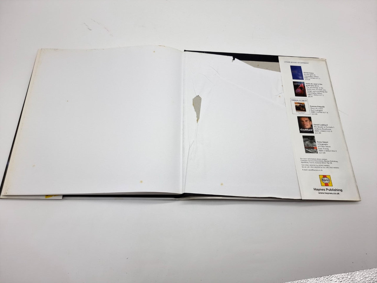 Open book with blank white pages and printed info panel on right