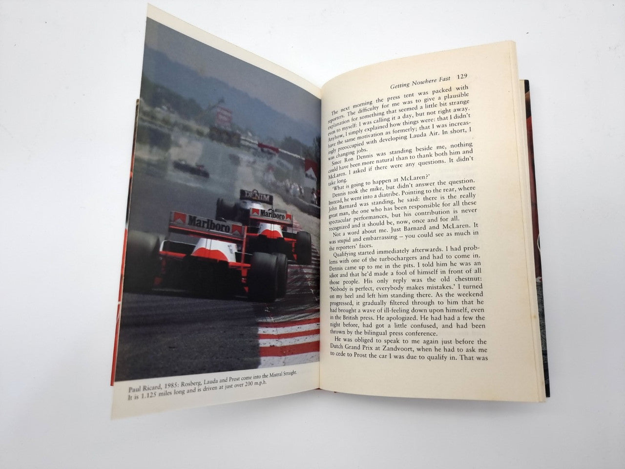 Open book with racing photo on left page and paragraph text on right