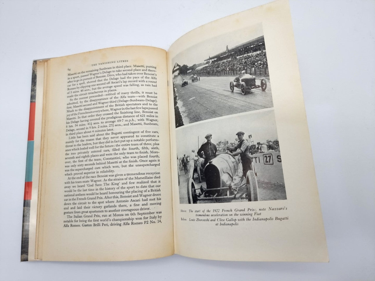 Vintage motorsport book open, left page text and right page race track photo