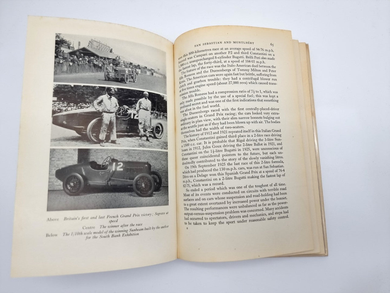 Vintage motorsport book open, pages with black-and-white car photos and paragraphs