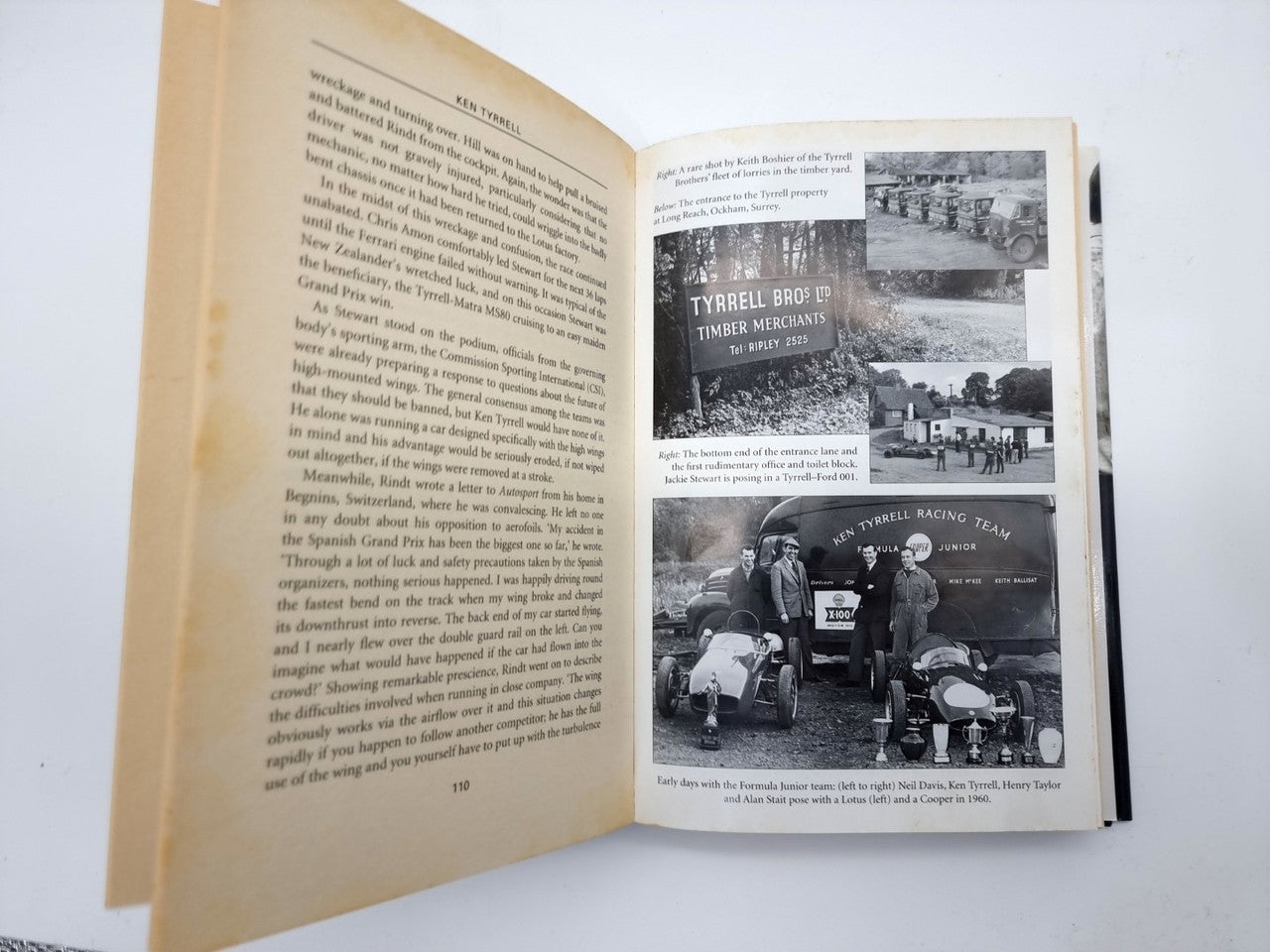 Open biography book with printed text and multiple black-and-white photo inserts