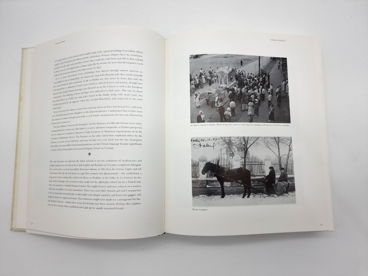 Open portfolio book with printed text on left and two animal photos on right