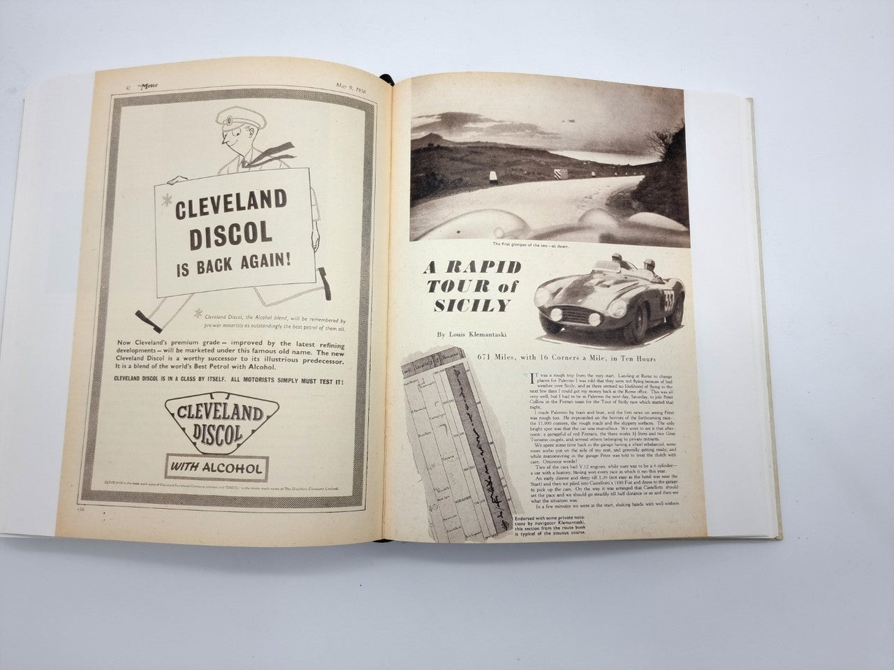 Open vintage book with illustrated ads on the left and a black-and-white sports car image