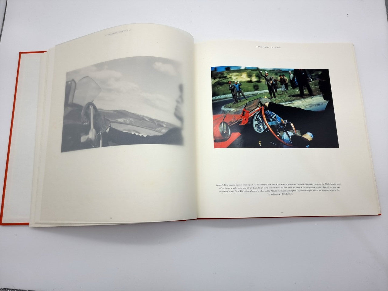 Open portfolio book with grayscale and color vehicle photos across two pages