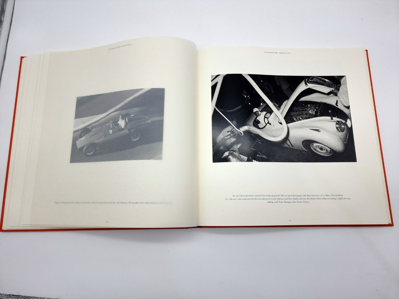 Open photo portfolio book spread with two black-and-white vehicle pictures