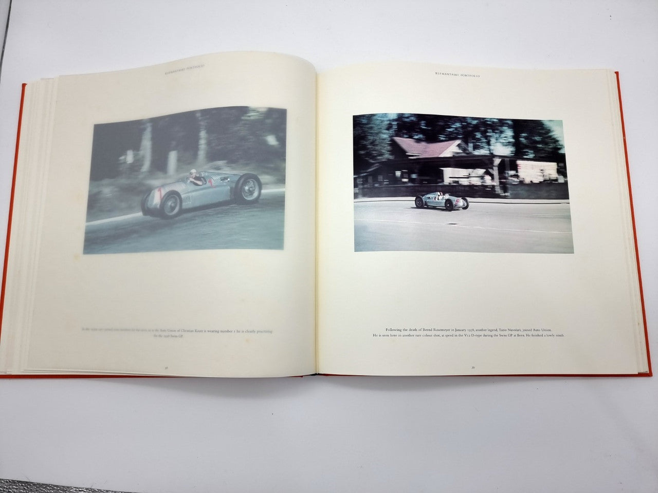 Open portfolio book spread with two black-and-white car photos