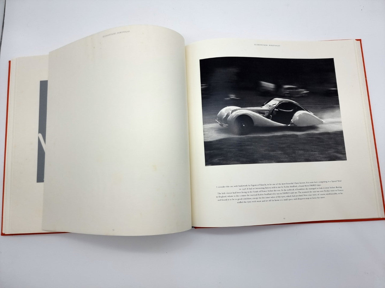 Open portfolio book with large grayscale car photo on right page