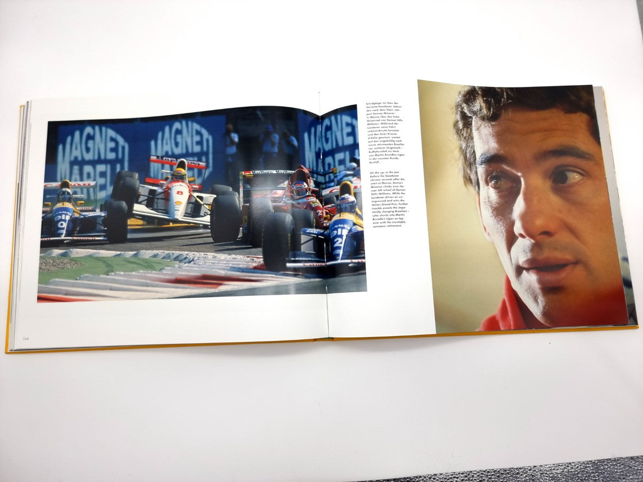 Open motorsport book with two photo pages and surrounding blocks of text