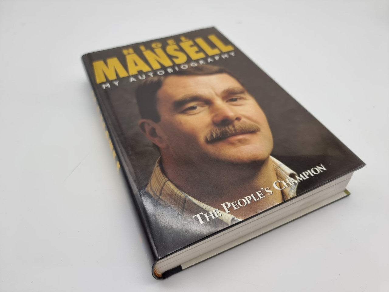 Autobiography book cover with Nigel Mansell portrait and 'The People’s Champion' text