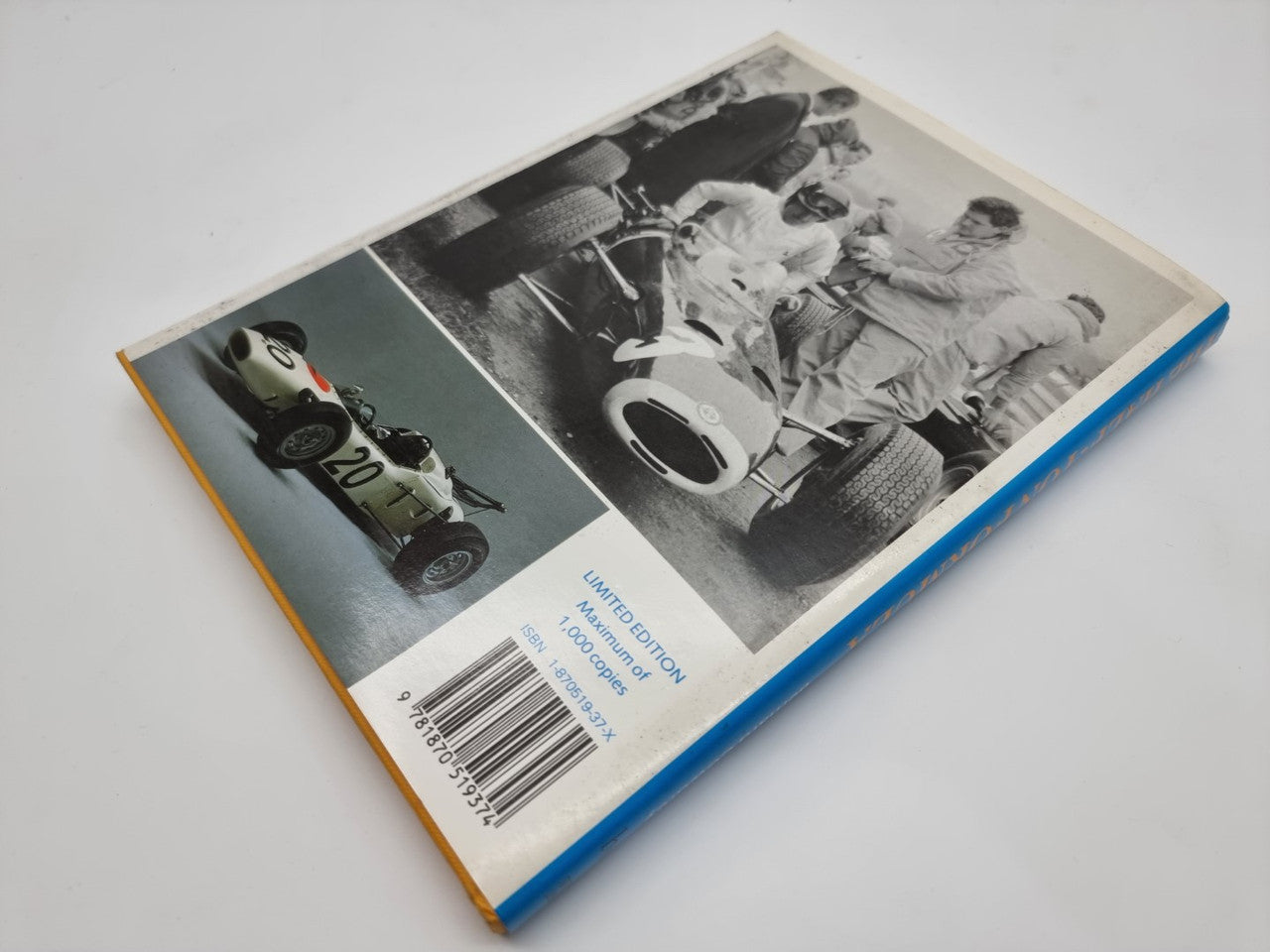 Motor racing book opened showing black-and-white F1 car photos on pages