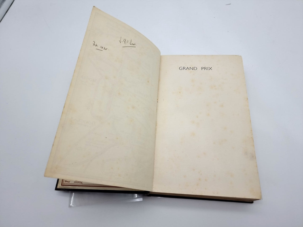 Grand Prix hardback book open to blank cream pages with notes