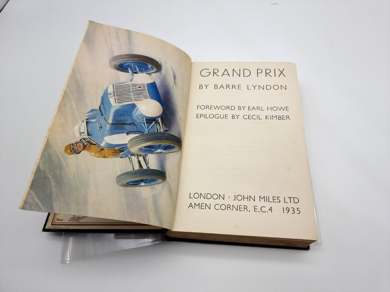 Grand Prix hardback book open, showing title page with blue racing car illustration