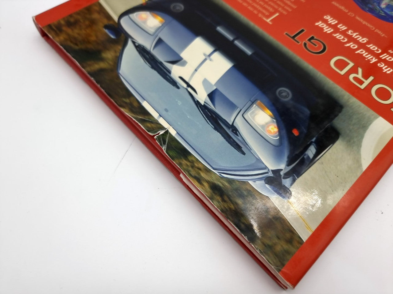 Hardcover Ford GT book corner showing blue car photo on the red cover