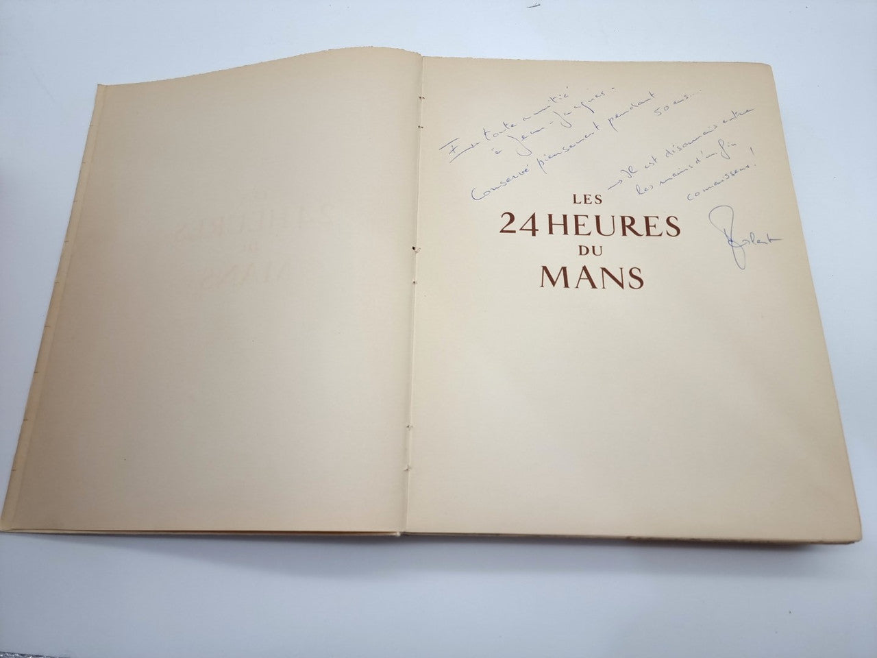 Open beige book showing centered “Les 24 Heures du Mans” title on right page