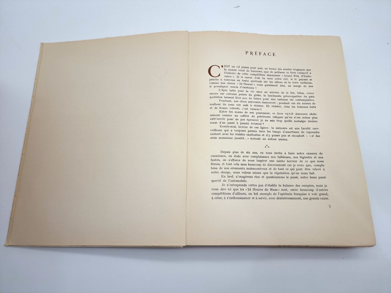 Open beige book with “Preface” heading and printed text