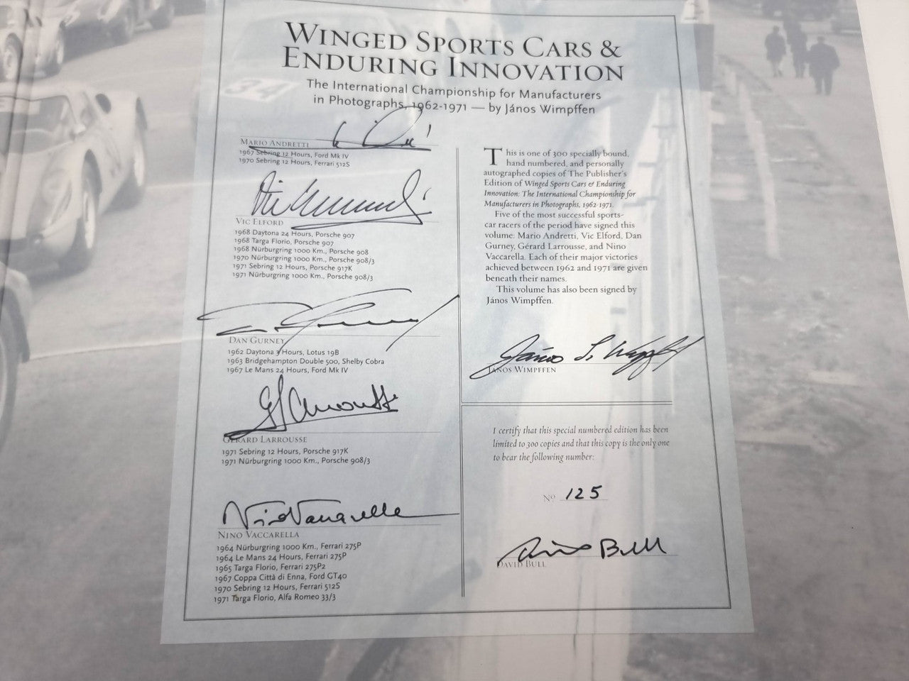 Signed book certificate page with multiple handwritten autographs and printed text
