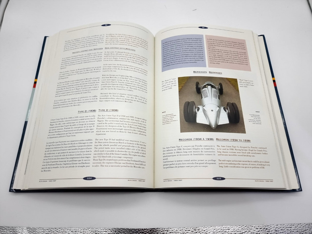 Open hardcover book with vehicle engine photo on the right page and text on both sides