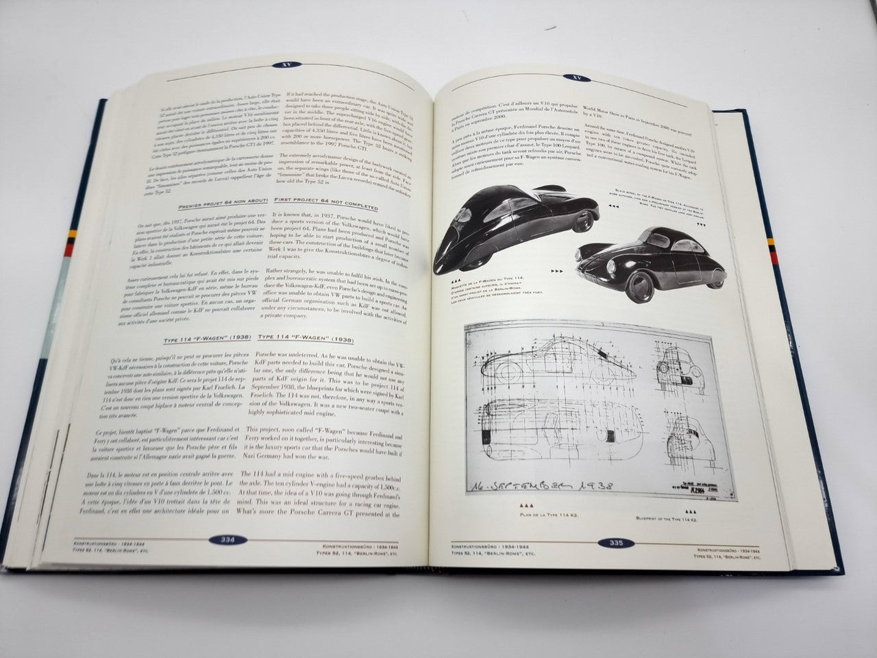 Open hardcover book spread with text columns, diagram, and vehicle photo illustrations