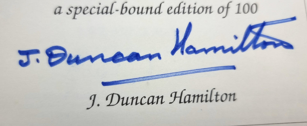 Signed book page with blue J. Duncan Hamilton autograph