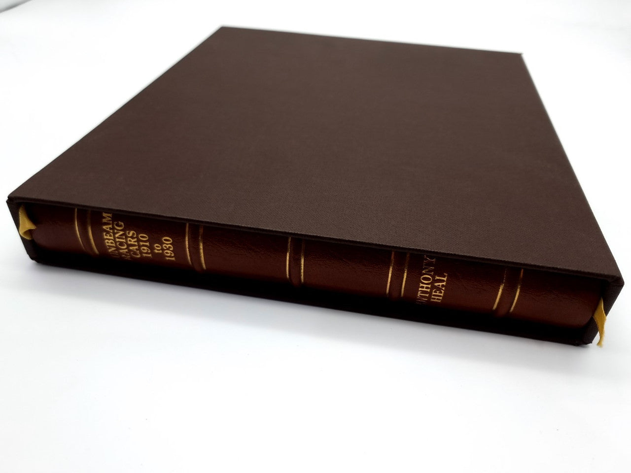 Brown leatherbound book with gold lettering on spine, book closed