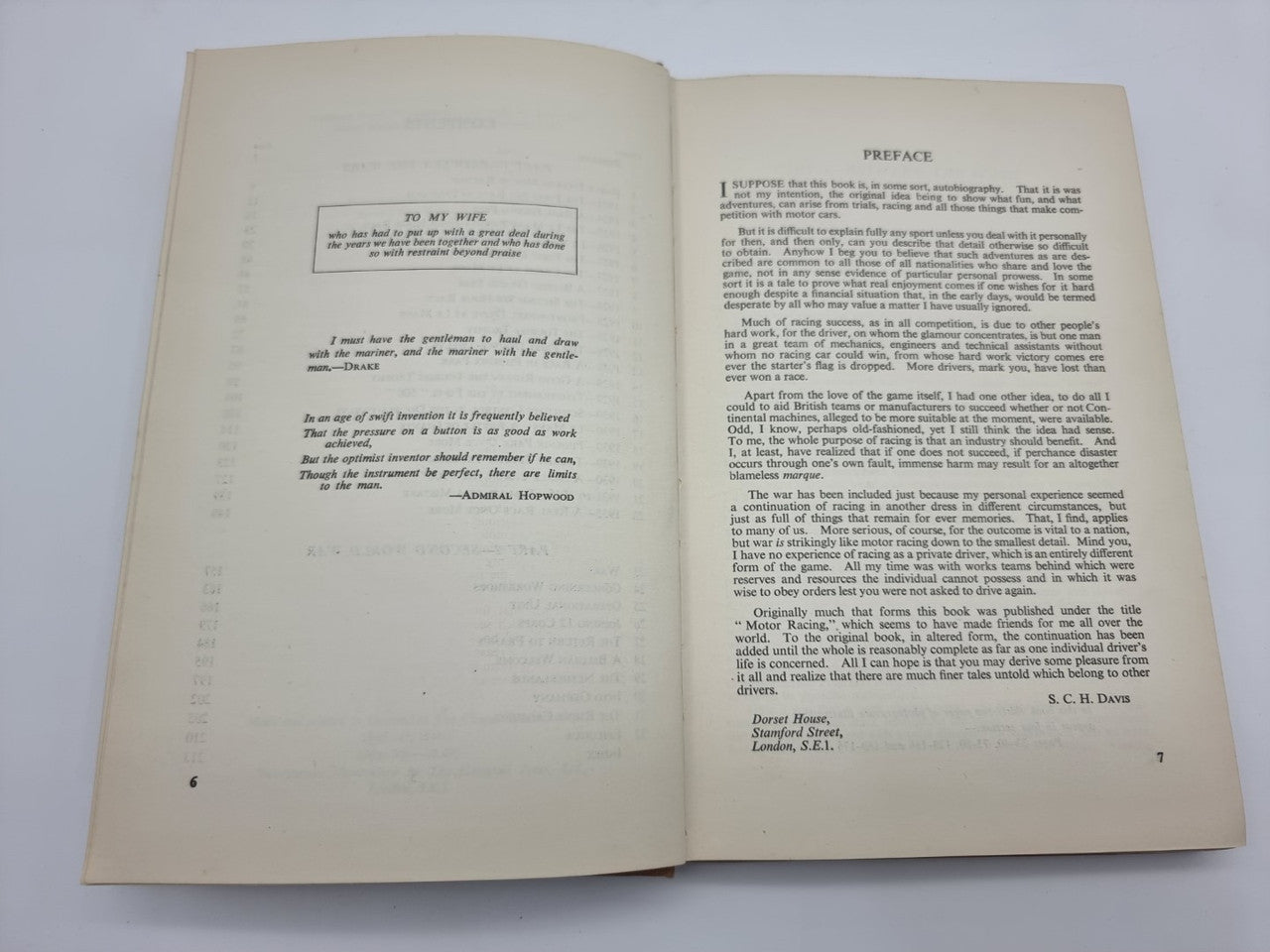 Hardcover book opened to pages of printed text and small chapter headings