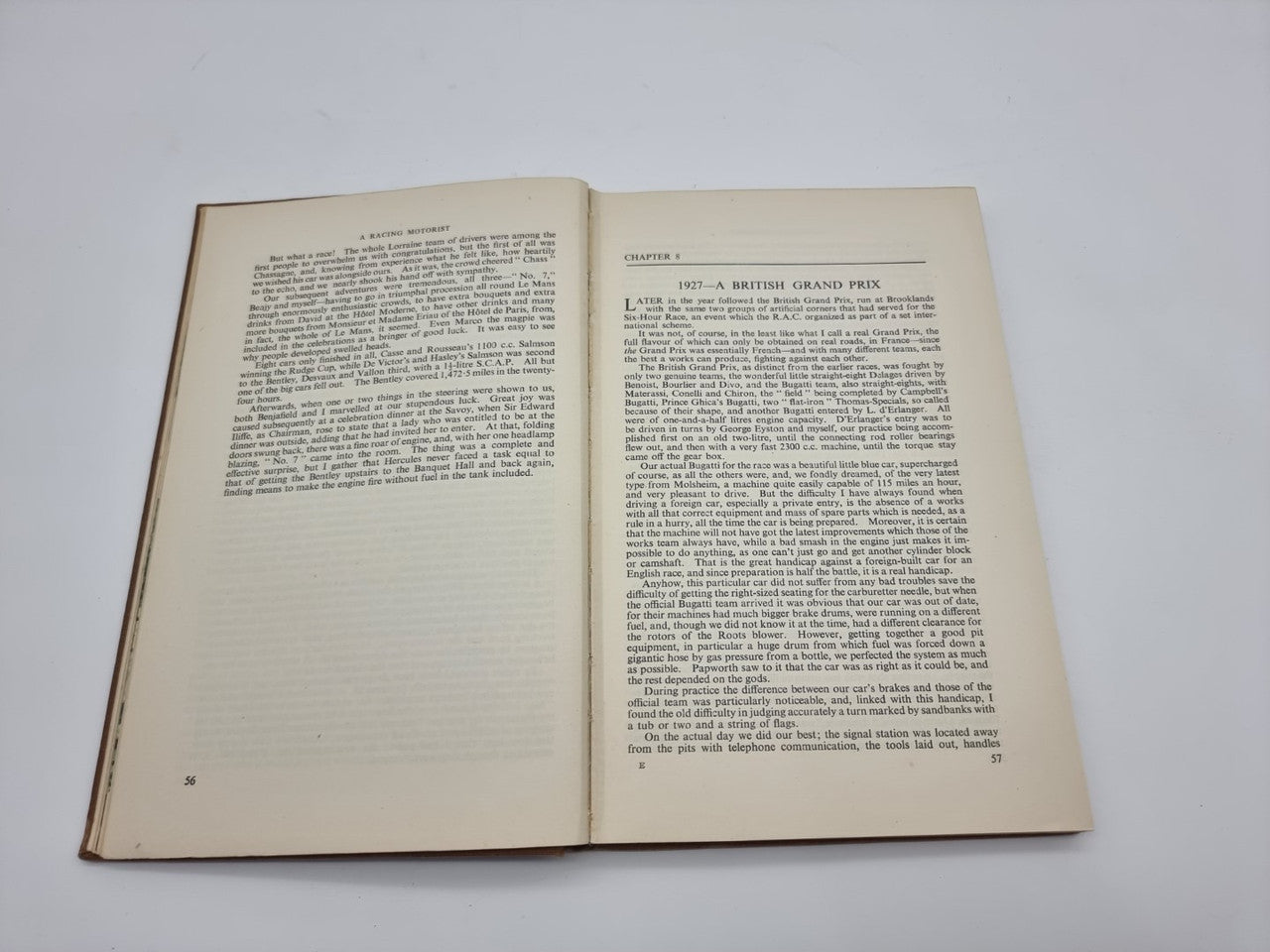 Hardcover book opened to two pages of printed racing history text