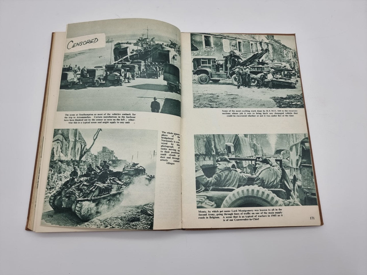 Hardcover book opened to black-and-white vehicle photos with caption text