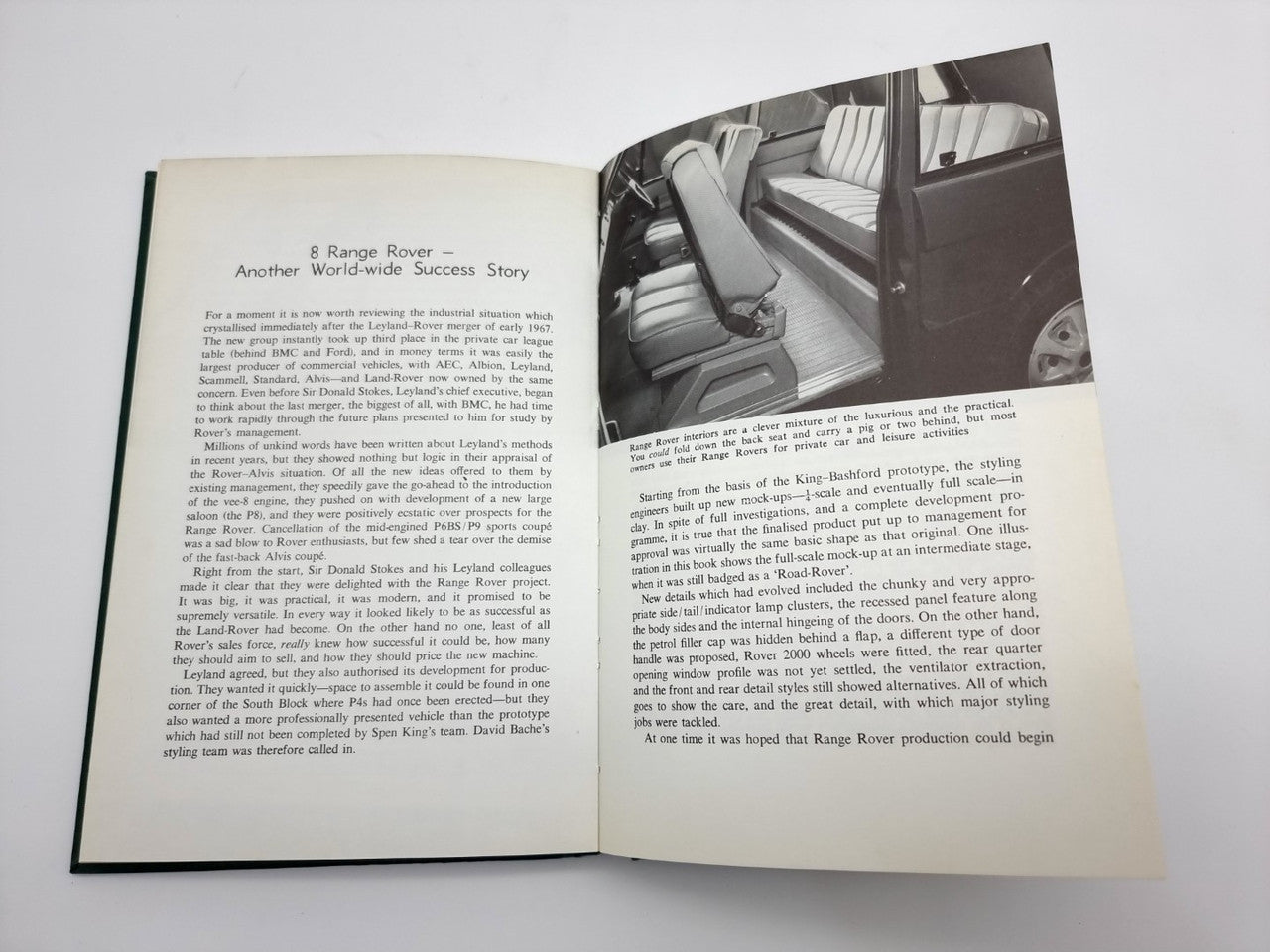 Book open to an illustrated chapter spread with a black-and-white vehicle interior photo