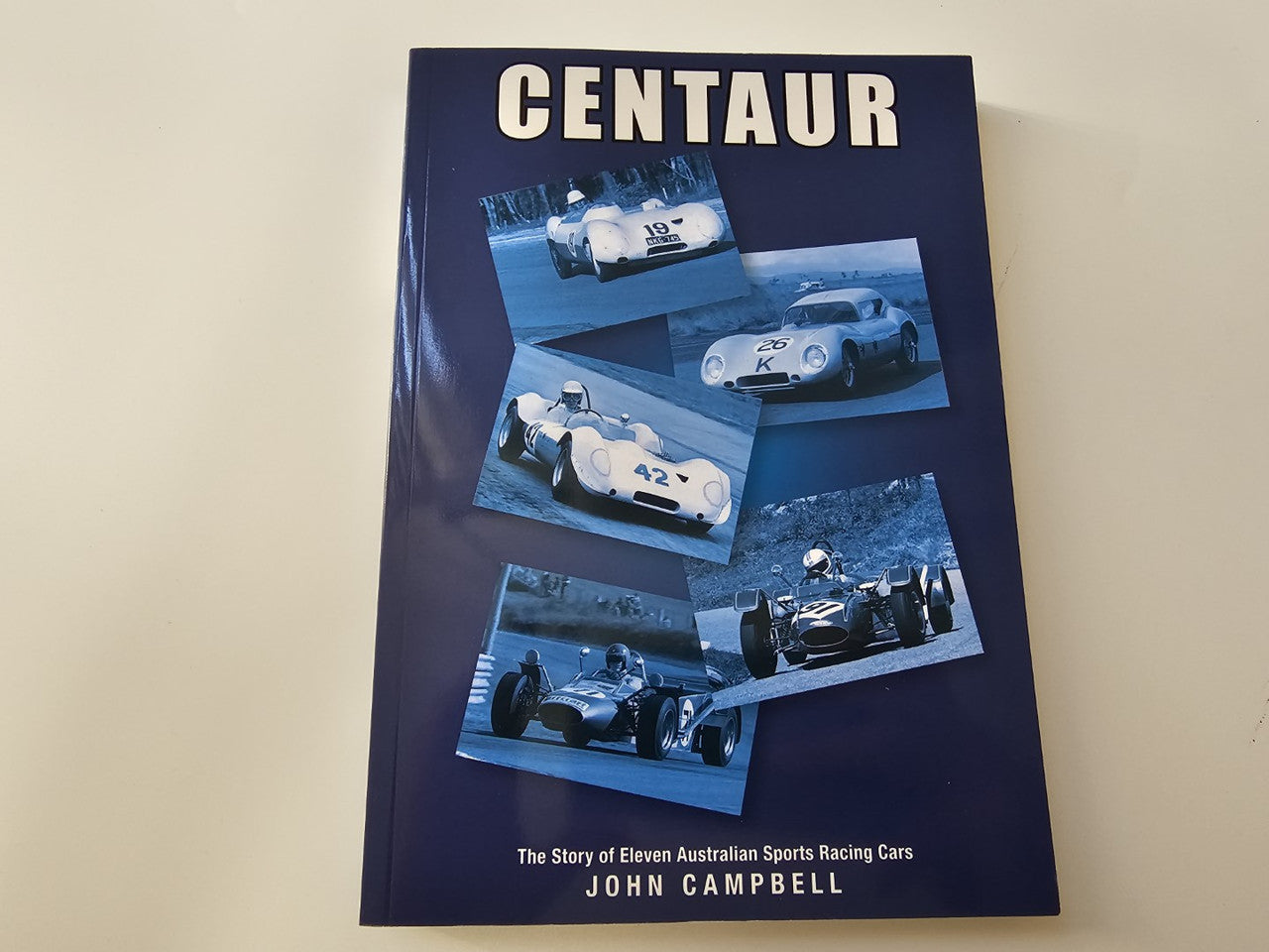 Front cover of Centaur motorsport history book with racing car collage and title