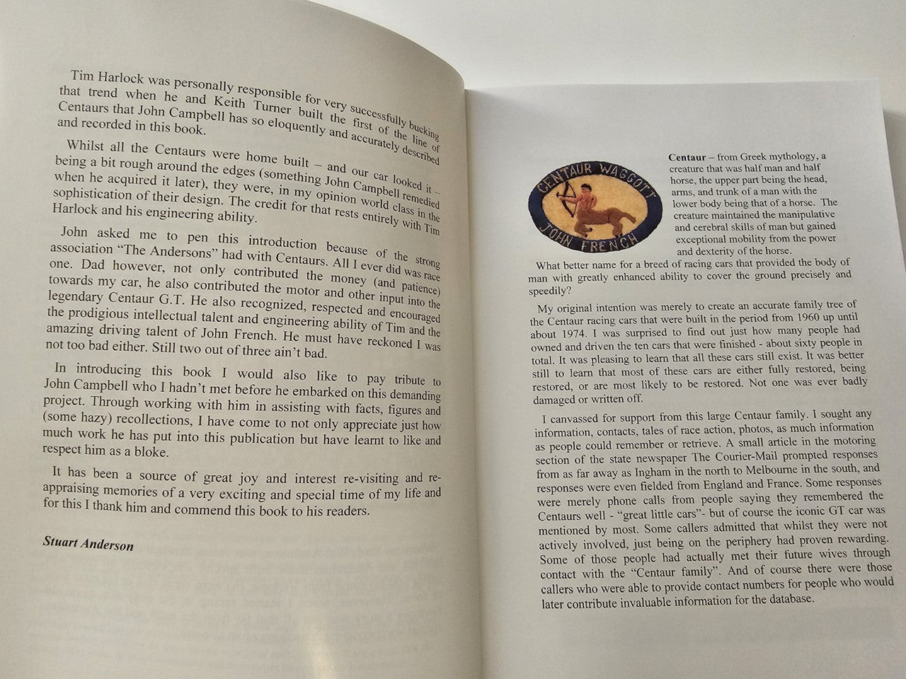 Signed motorsport history book, open pages with biography text and photos.