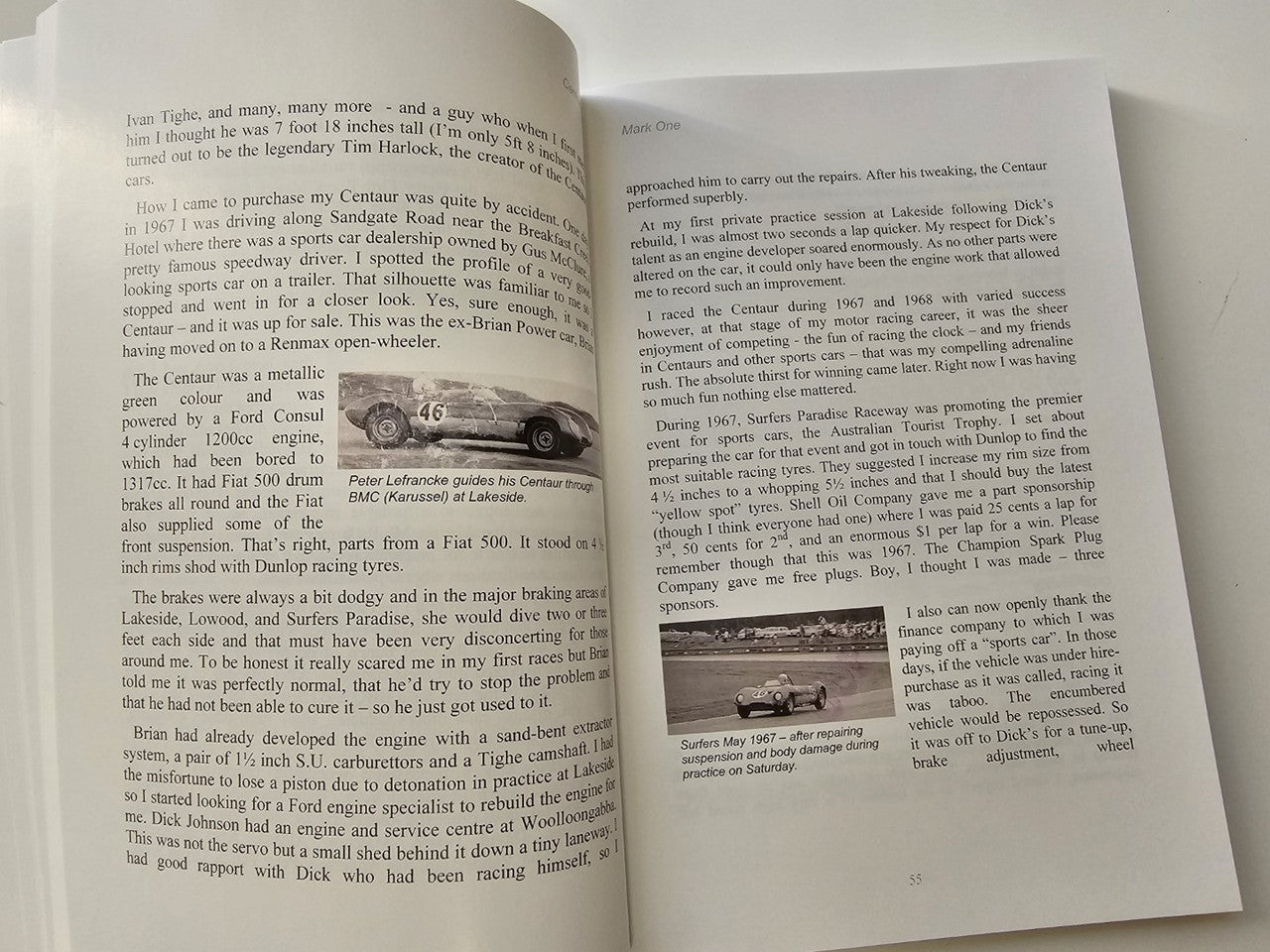 Book pages with a small vintage car photo and dense printed text columns