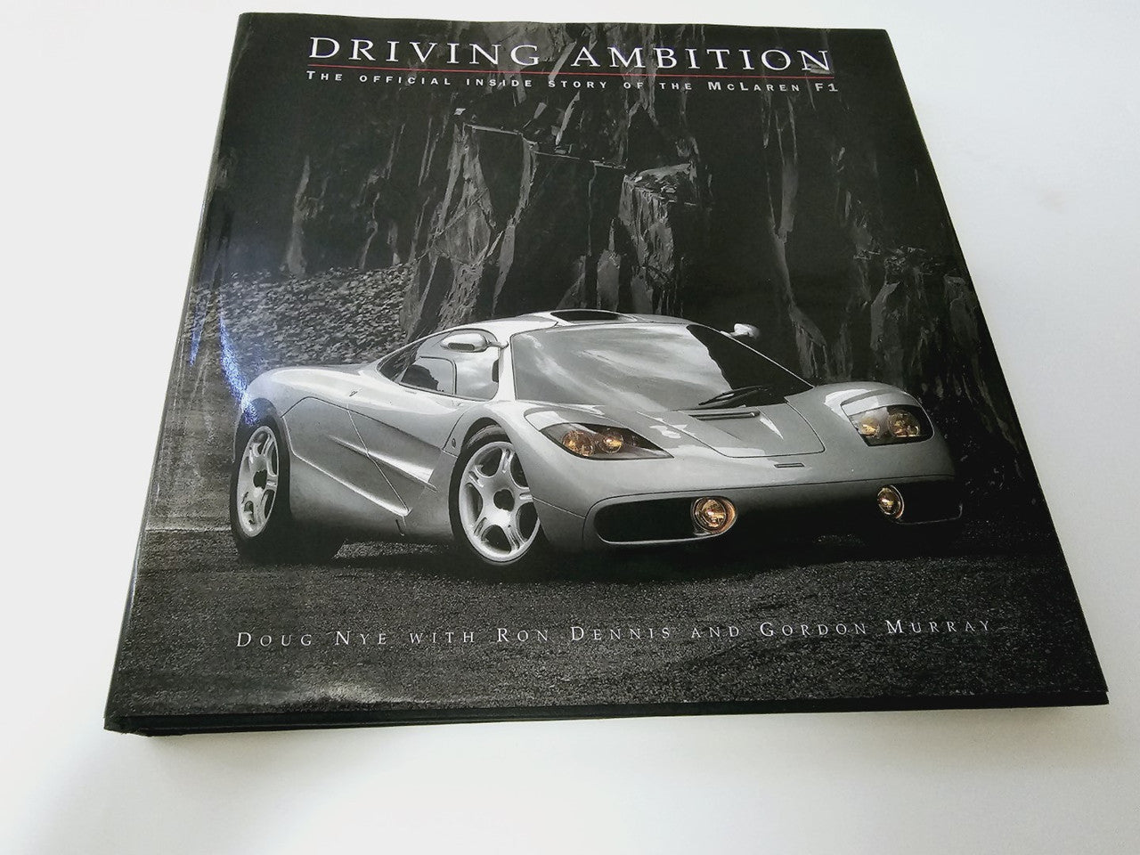 Driving Ambition book cover with a silver race car and title text