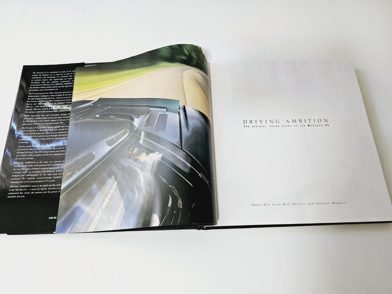 Open book showing a steering wheel cover image and the title-page page