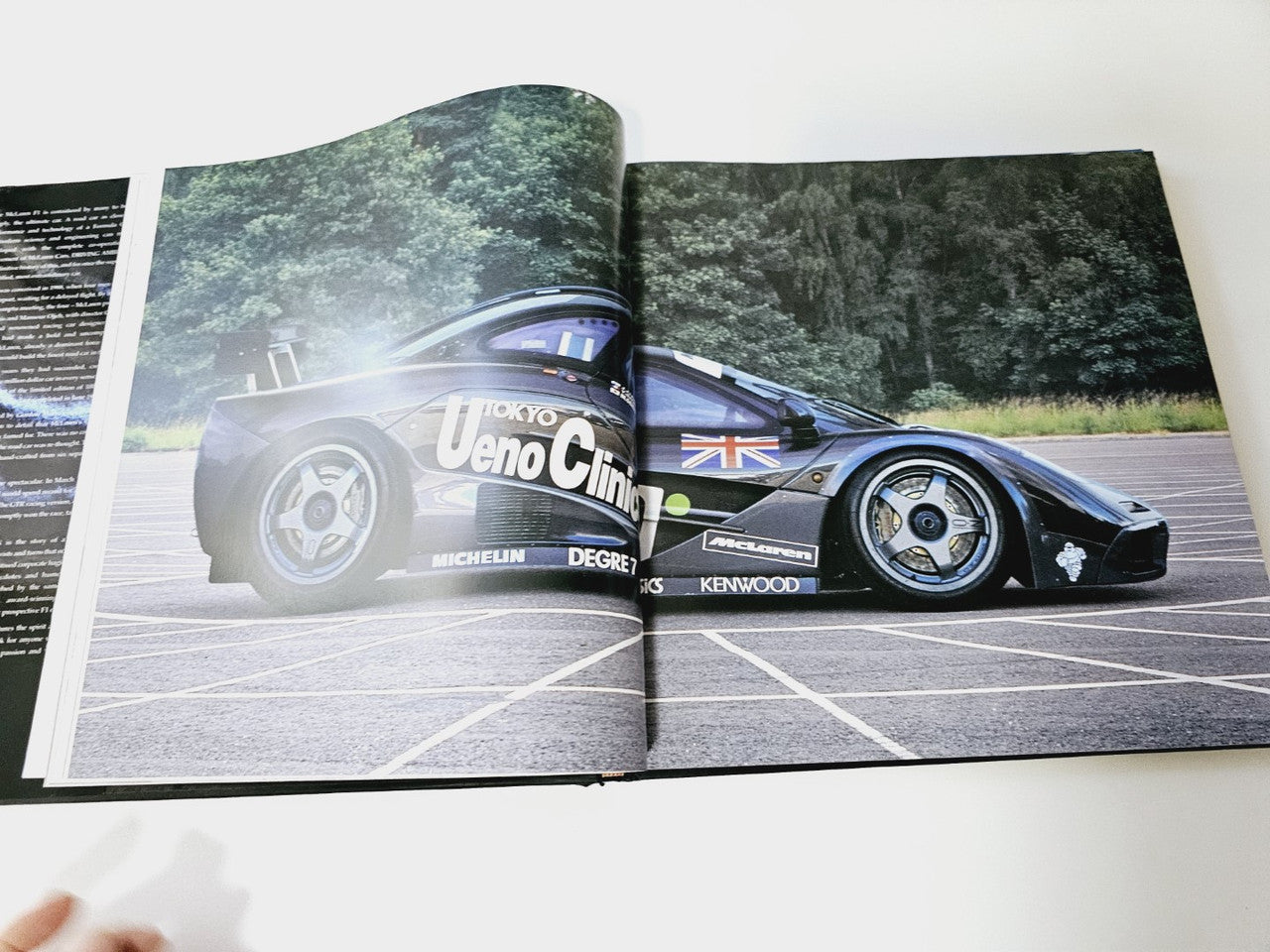 Open book showing a blue and white race car on a track