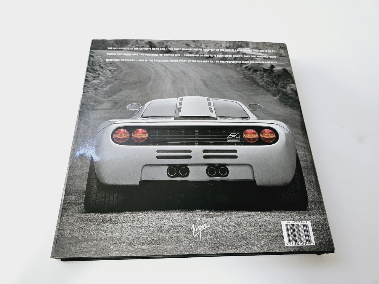 Hardcover book with a grayscale supercar photo on the front cover