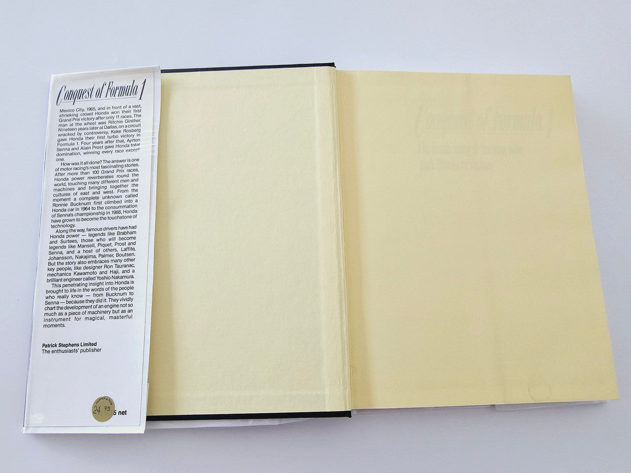 Open book with printed text on one page and two blank beige pages