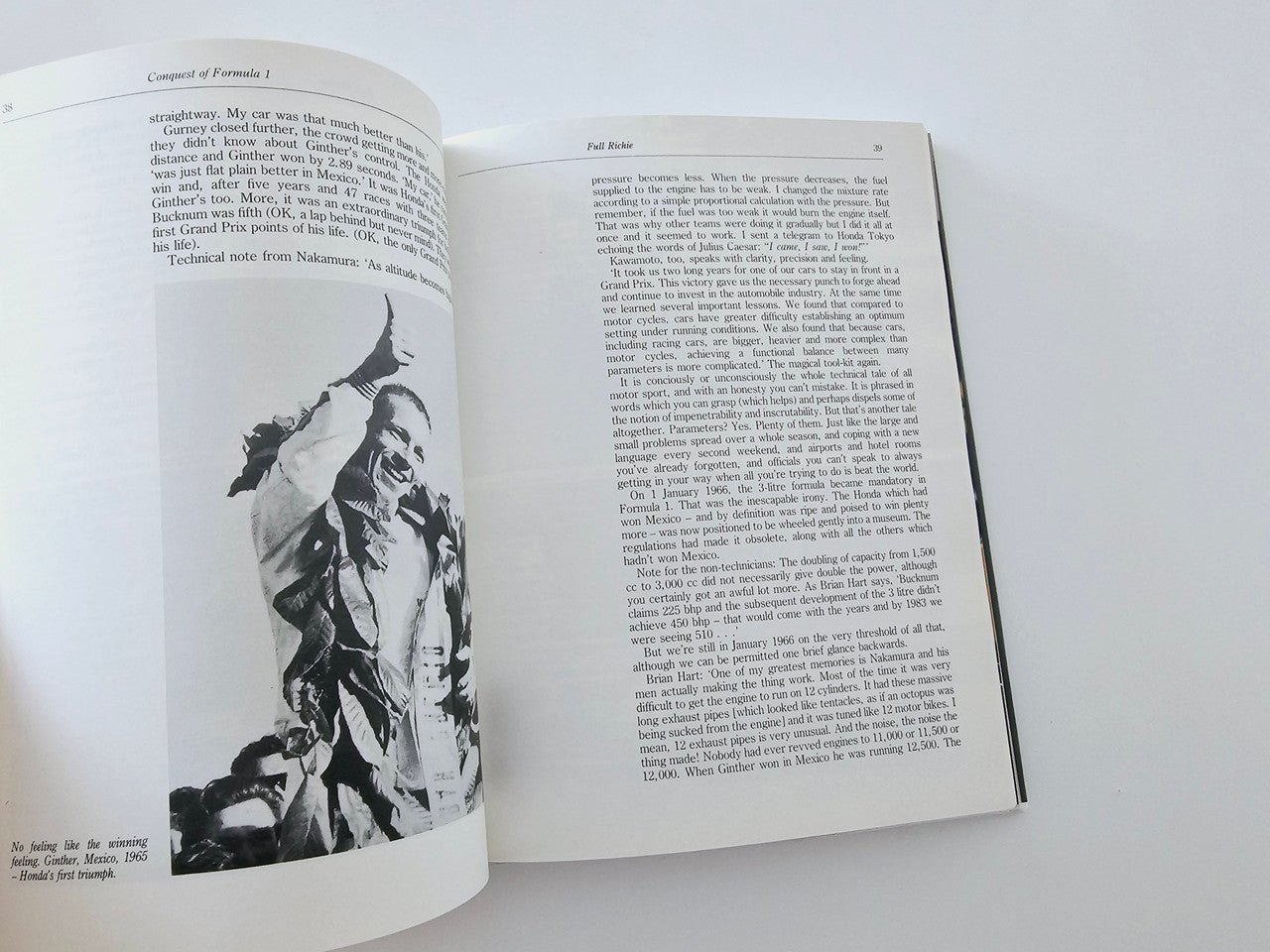 Open book with a black-and-white portrait photo and dense text pages
