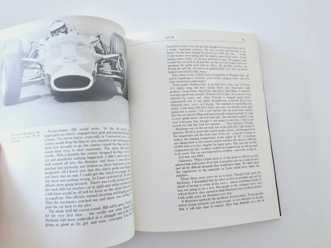 Open book showing a black-and-white car photo on the left and text on the right