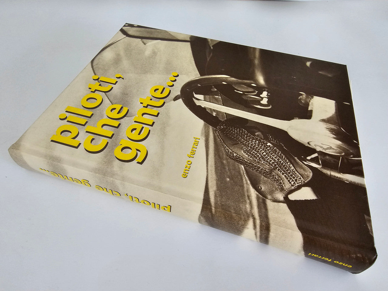Ferrari racing book cover with yellow lettering and a black-and-white driver photo.