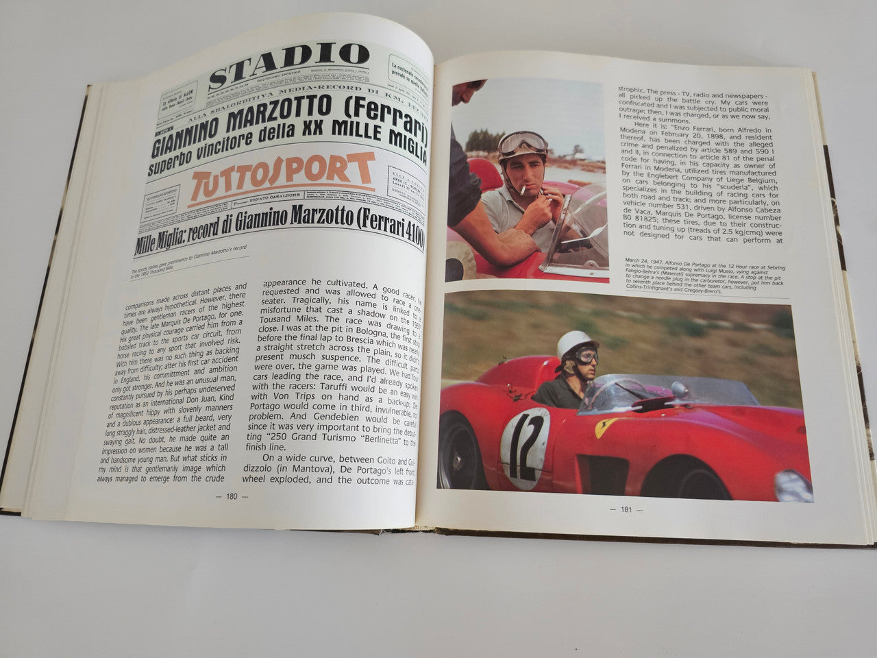 Ferrari racing book open pages with racing text and a driver in a red car.