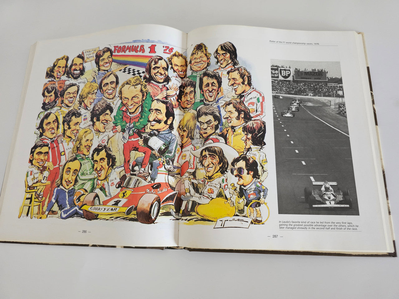 Ferrari racing book open spread with illustrated racing figures and a track photo.