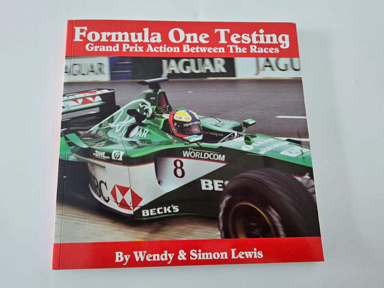 Formula One motorsport photo book cover with race car image and title text