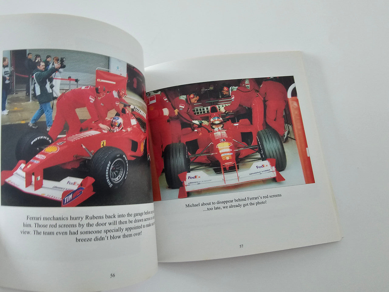 Open book spread showing red Formula One race cars on both pages