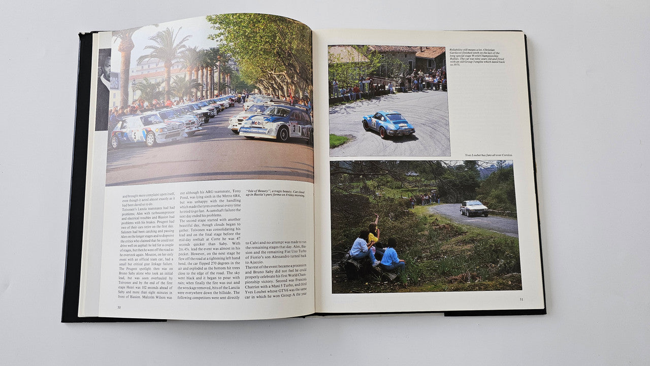 Open rallying book showing racing photo pages and printed text spread