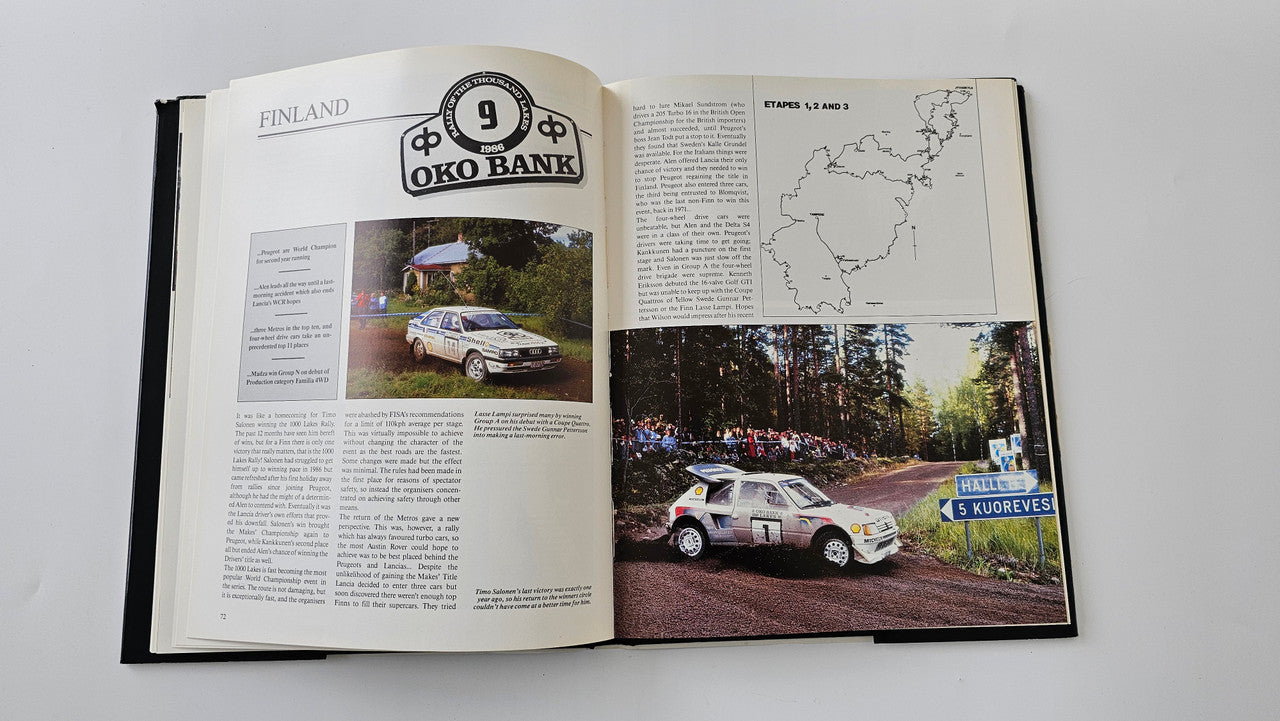 Open rallying book with car photo spread, map graphic, and printed text